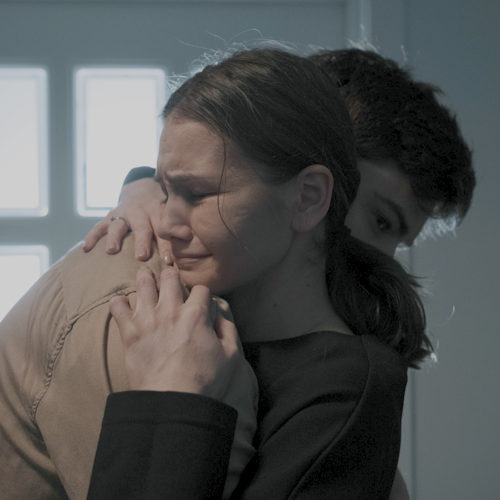 Teenage boy and girl consoling each other